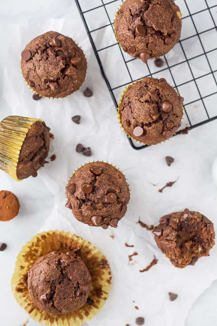 overhead photo of the best skinny double chocolate banana muffins scattered on a board