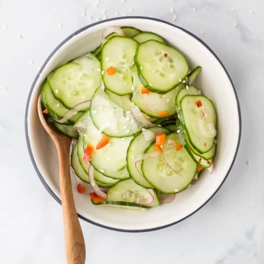 overhead photo of 10 Minute Easy Asian Cucumber Salad Recipe (Dairy Free) in a bowl with a spoon