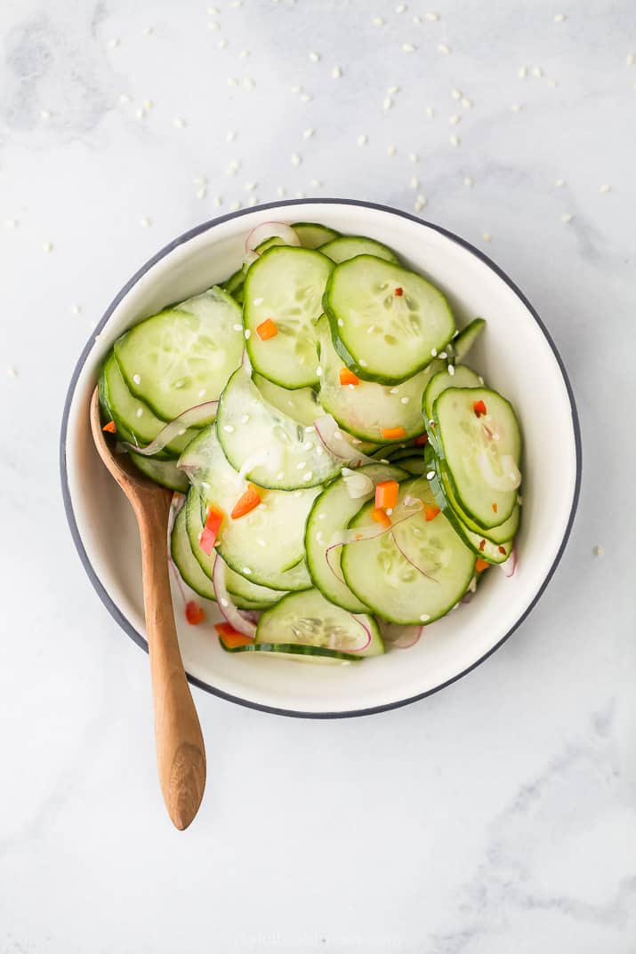 overhead photo of 10 Minute Easy Asian Cucumber Salad Recipe (Dairy Free) in a bowl with a spoon