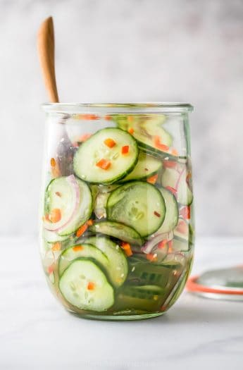 photo of 10 Minute Easy Asian Cucumber Salad Recipe (Dairy Free) in a glass jar with a spoon