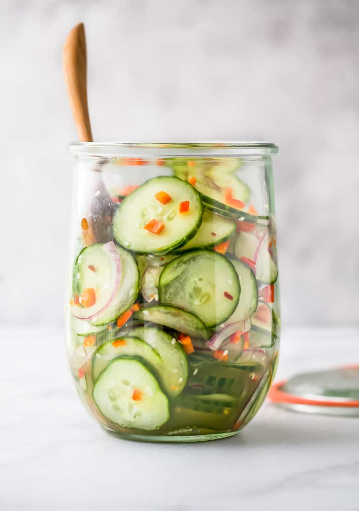 photo of 10 Minute Easy Asian Cucumber Salad Recipe (Dairy Free) in a glass jar with a spoon