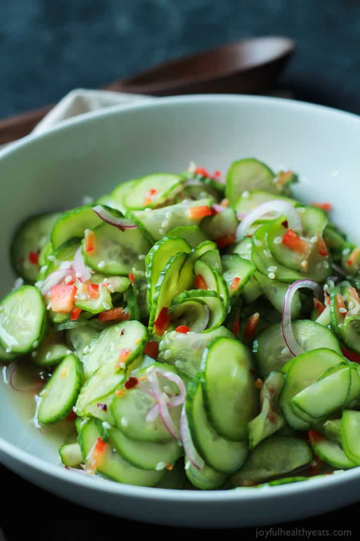 An easy to make Asian Cucumber Salad that's full of crunchy cucumber, rice wine vinegar, and a few secret ingredients! Can be served as a refreshing summer salad or the condiment to a sandwich! | joyfulhealthyeats.com 