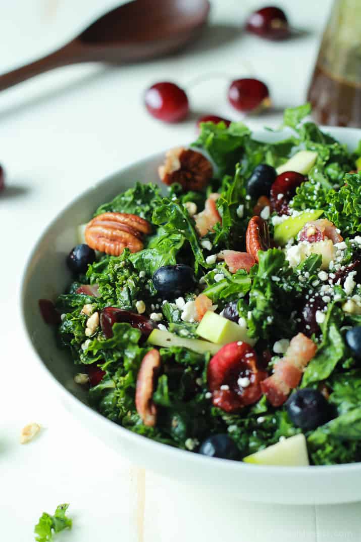 Summer Kale Salad with fresh cherries and blueberries, pecans, bacon and feta in a serving bowl