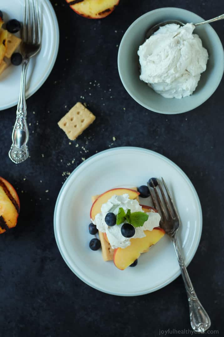 Top view of a serving of Grilled Peach Shortcake on a plate with fresh blueberries