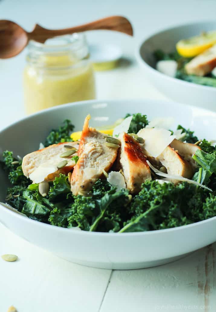 Easy Kale Chicken Caesar Salad with pepitas, shaved parmesan and a homemade egg and anchovy free Caesar Dressing! Its the perfect salad recipe to have for the summer! | joyfulhealthyeats.com 