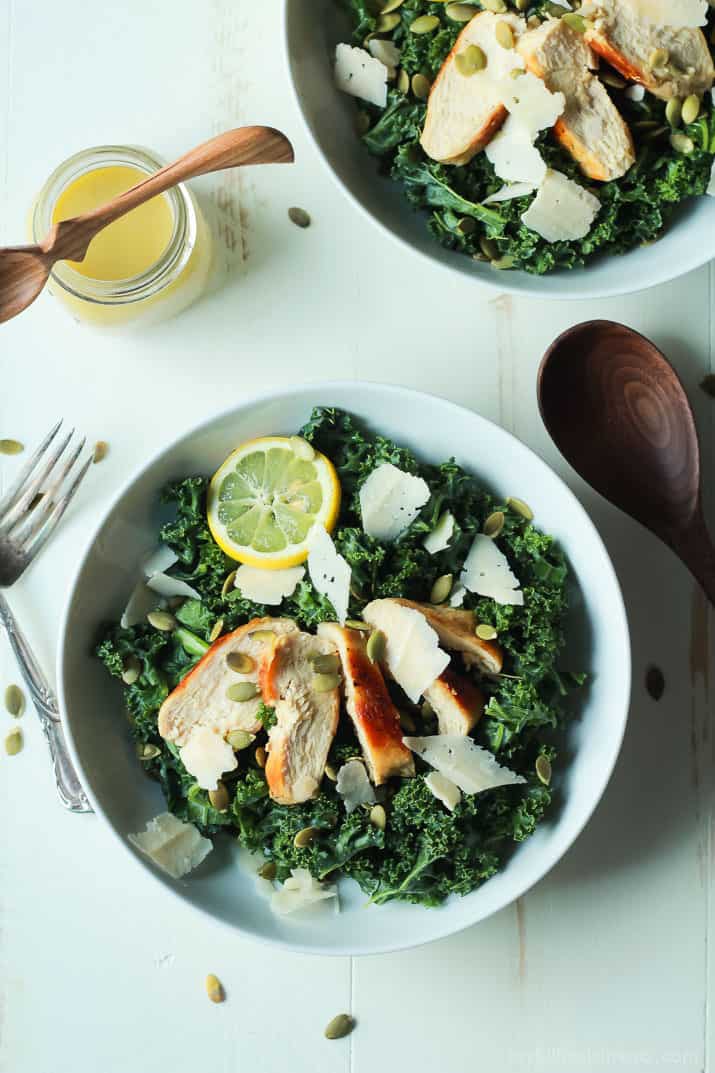 Easy Kale Chicken Caesar Salad with pepitas, shaved parmesan and a homemade egg and anchovy free Caesar Dressing! Its the perfect salad recipe to have for the summer! | joyfulhealthyeats.com 