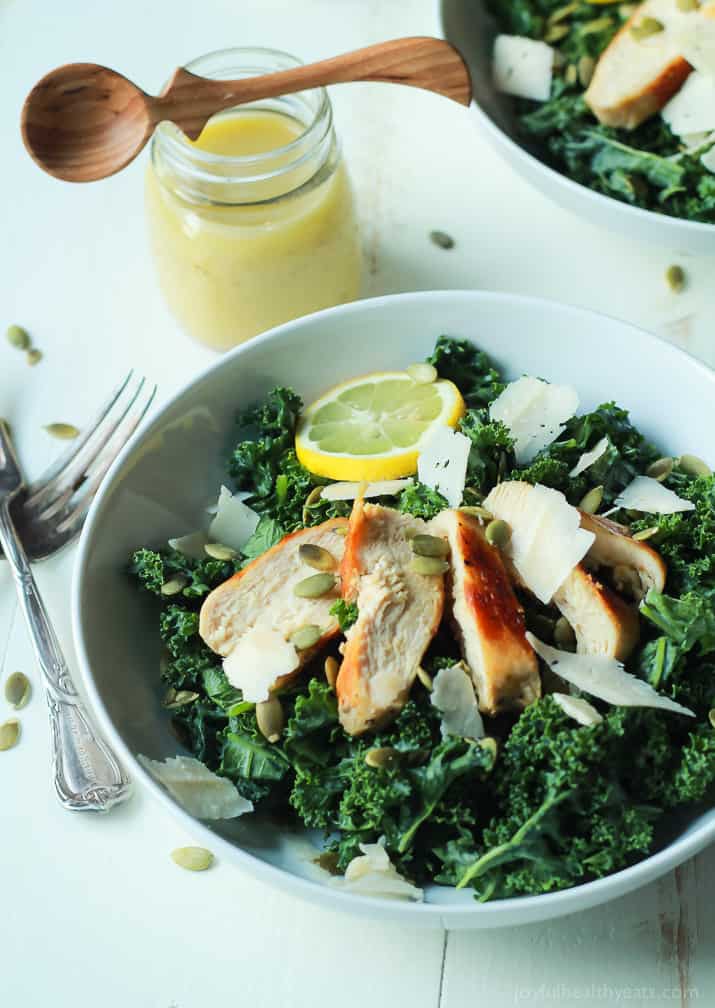 Easy Kale Chicken Caesar Salad with pepitas, shaved parmesan and a homemade egg and anchovy free Caesar Dressing! Its the perfect salad recipe to have for the summer! | joyfulhealthyeats.com 