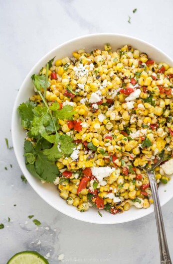 spoon scooping some summer corn salad out of a bowl