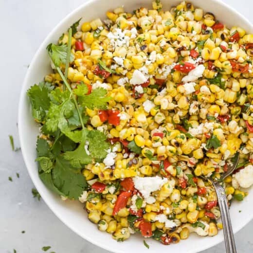 spoon scooping some summer corn salad out of a bowl