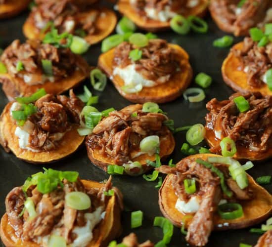 BBQ Pulled Pork Sweet Potato Bites are sure to be a family favorite. Topped with creamy whipped goat cheese and moist BBQ Pulled Pork with a few secret ingredients - you'll be addicted after one! | joyfulhealthyeats.com #appetizer #gameday #recipes