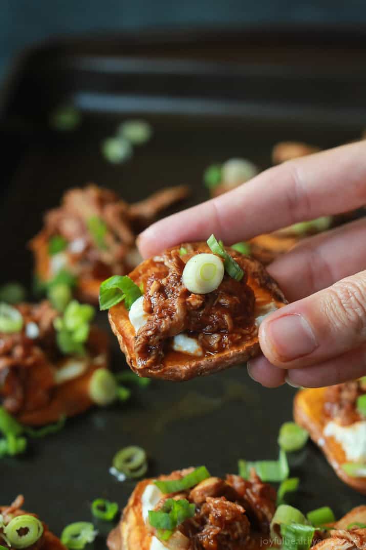 A hand holding a BBQ Pulled Pork Sweet Potato Bite