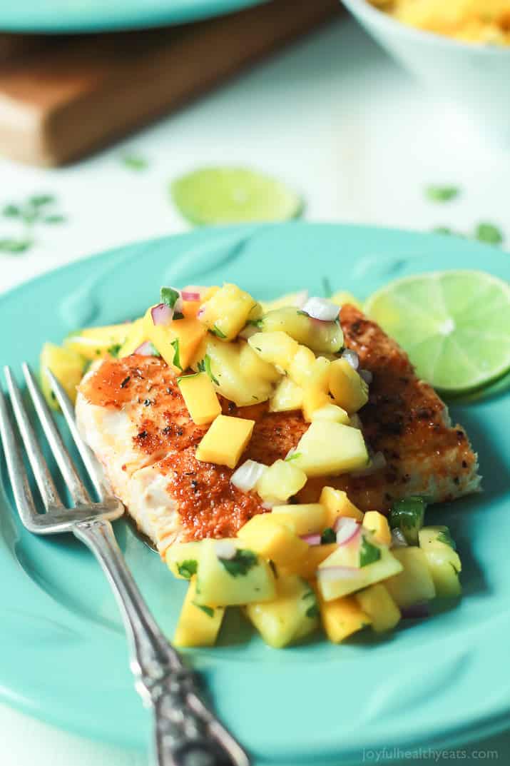 Seared Cajun Mahi Mahi topped with a fresh Mango Pineapple Salsa on a plate