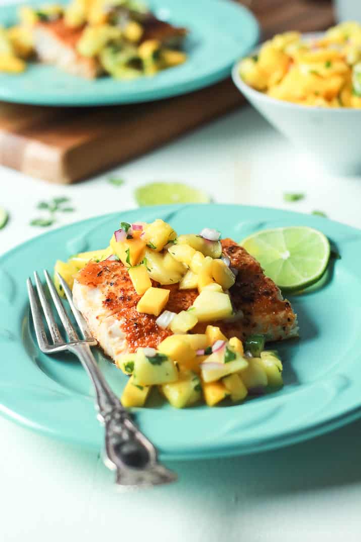 Pan Seared Cajun Mahi Mahi with a fresh Mango Pineapple Salsa on a plate with a fork