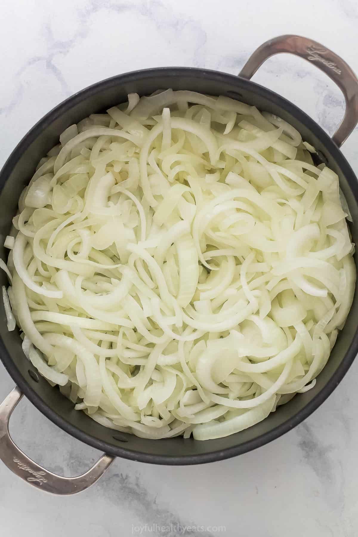 Onions cooking in skillet.