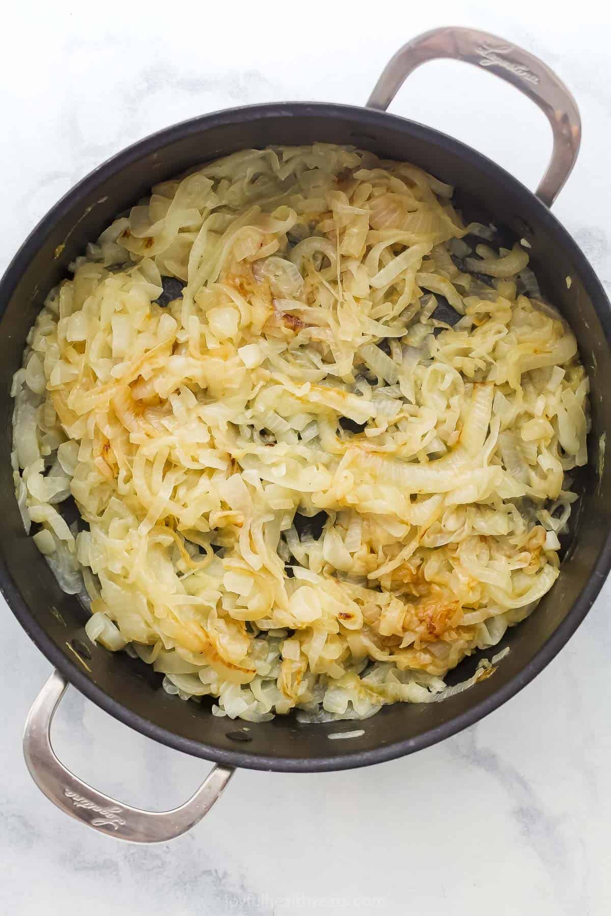 Onions cooking down in skillet.