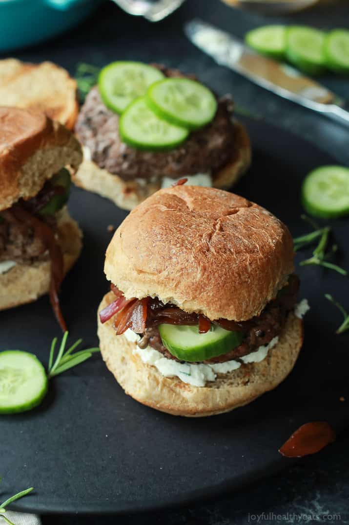 Grilled Lamb Burgers topped with whipped feta cheese, cucumber, and balsamic caramelized onions