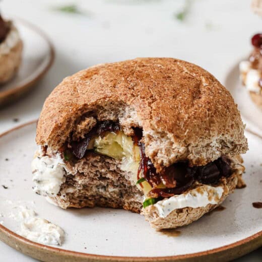 Bitten-into burger with herby whipped feta spread.