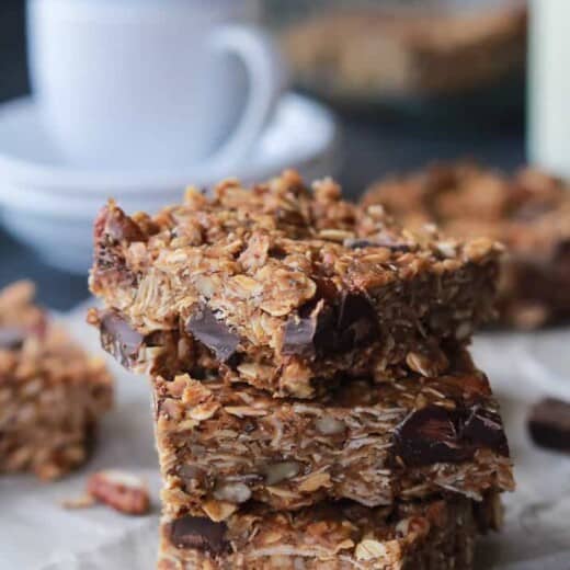 Pieces of No Bake Peanut Butter Chocolate Bars stacked on top of each other.