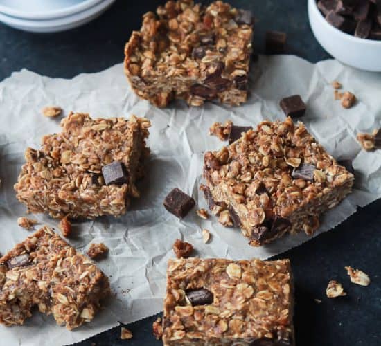 Pieces of No Bake Peanut Butter Chocolate Bars on parchment paper.