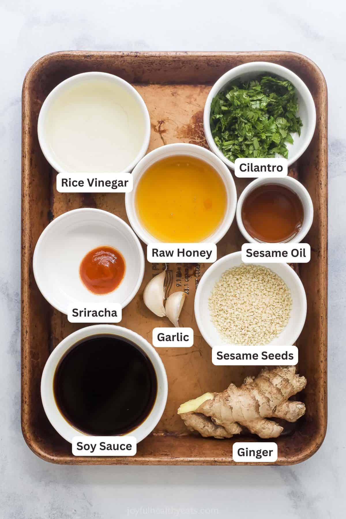 Ingredients for sesame ginger vinaigrette with labels.