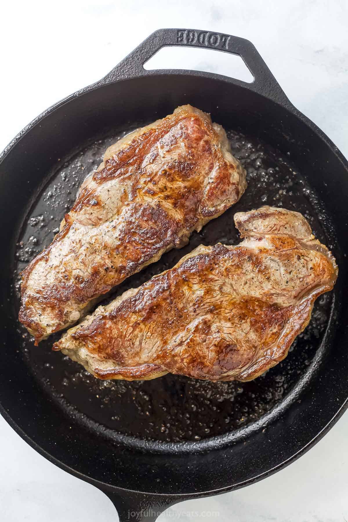Steak searing in cast iron skillet.