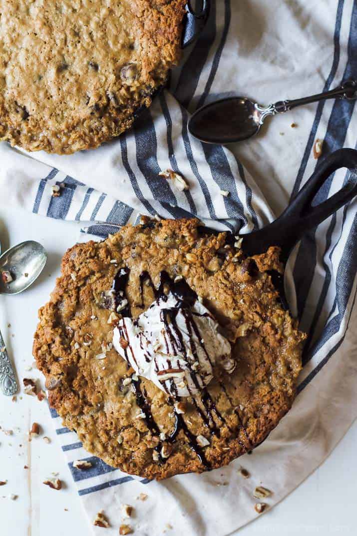 Top view of Coconut Oatmeal Chocolate Chip Skillet Cookie topped with vanilla ice cream and chocolate drizzle