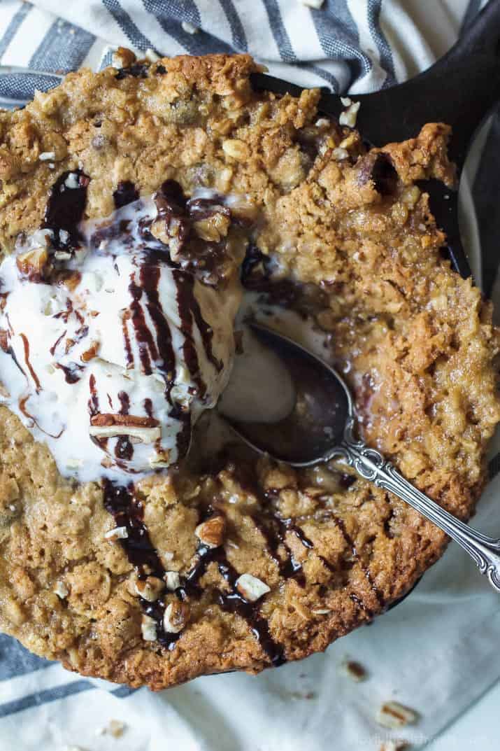 Top view of Coconut Oatmeal Chocolate Chip Skillet Cookie topped with vanilla ice cream and chocolate drizzle