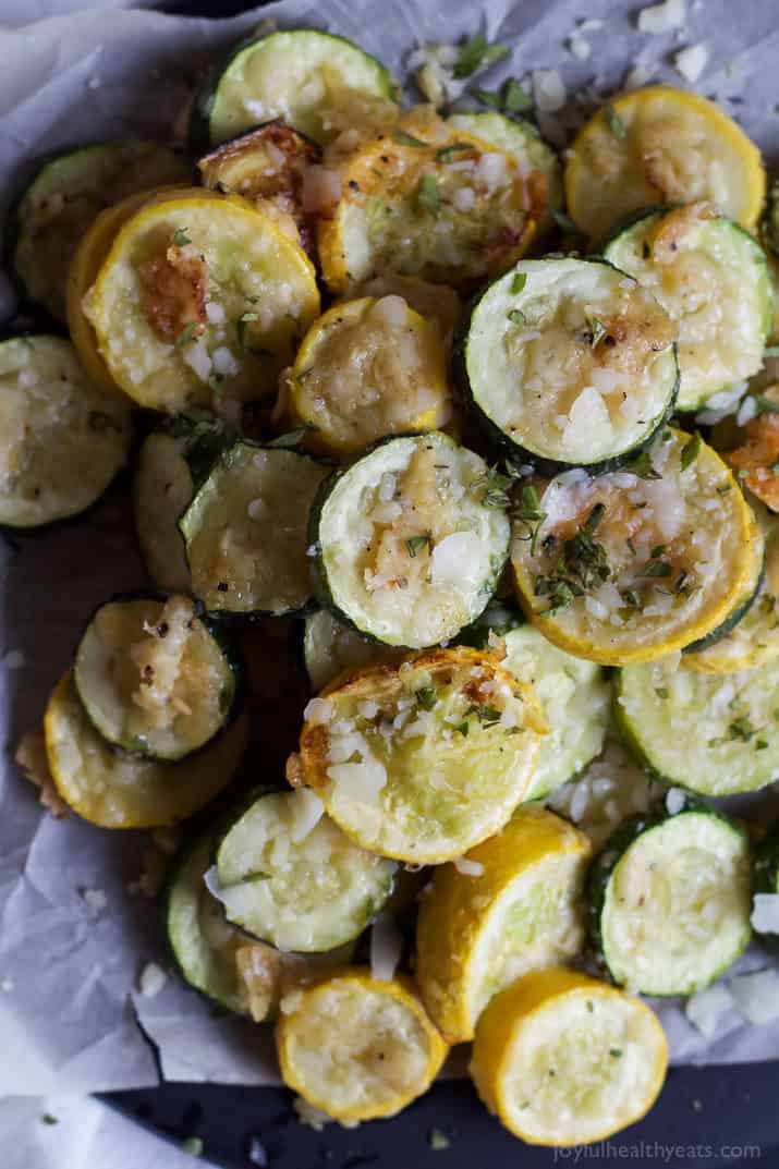 Top view of Crispy Parmesan Garlic Zucchini Chips on parchment paper