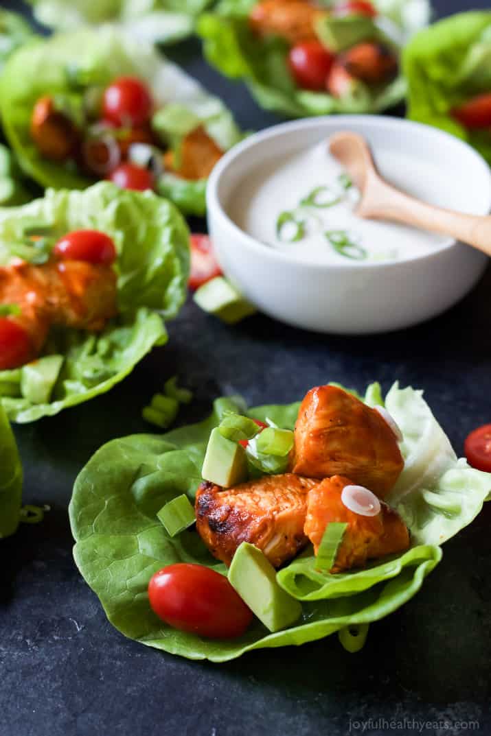 Grilled Buffalo Chicken Lettuce Wraps with a bowl of creamy dressing