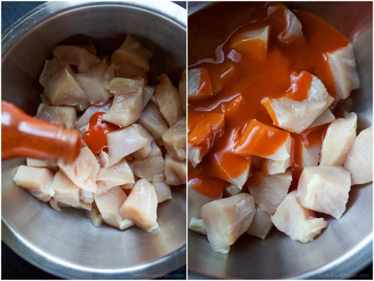 Buffalo sauce being poured over raw chicken pieces in a bowl