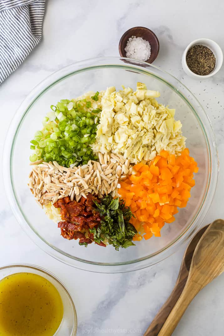 A Bowl Filled with Slivered Almonds and Prepared Veggies for Orzo Salad