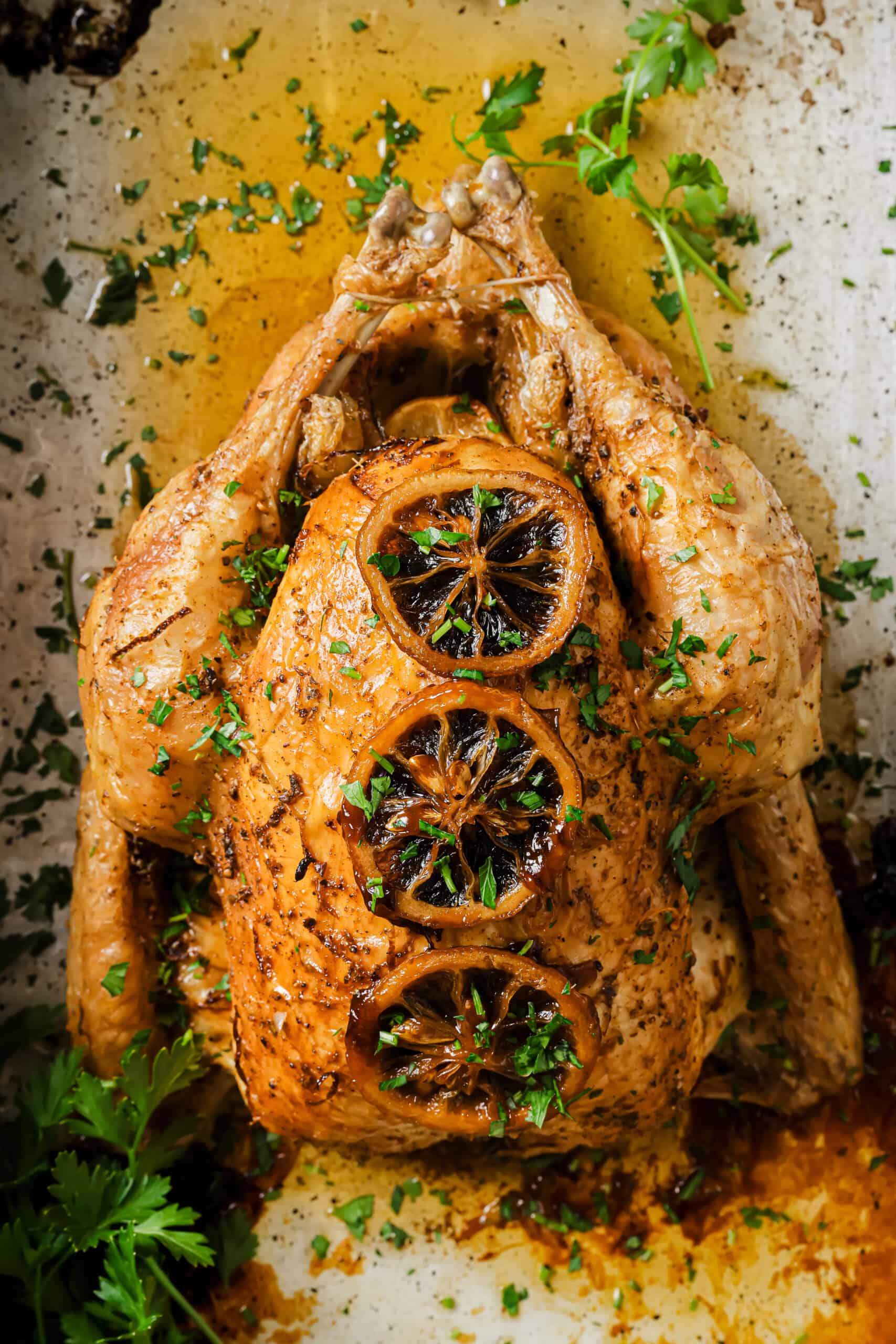 With crispy skin and zesty butter, this bake-and-forget roasted chicken recipe will be a weeknight favorite! Roasted chicken recipe in the baking pan.