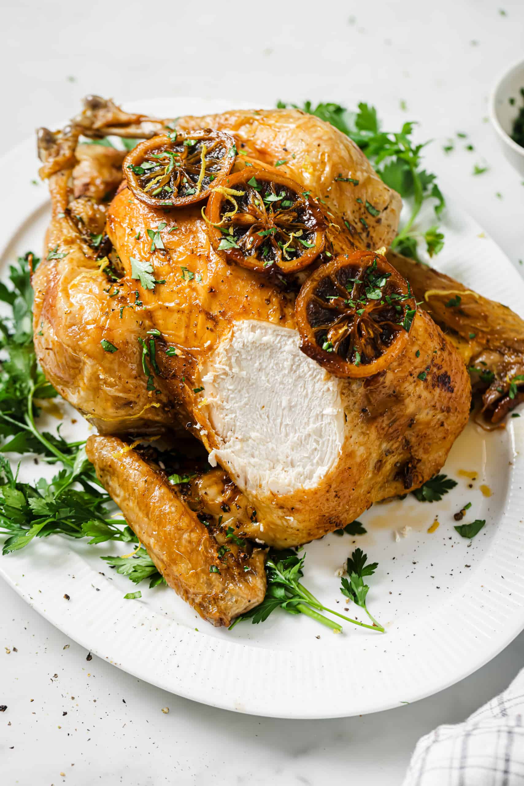 Roasted chicken recipe with a chunk sliced off. 