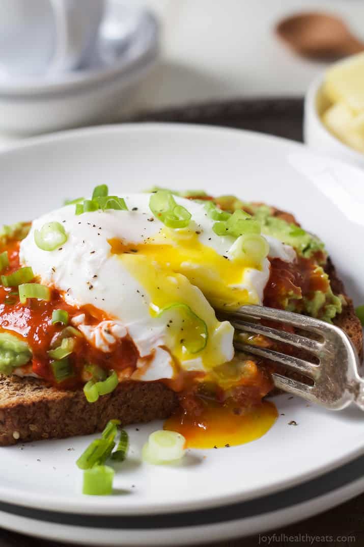 Ricotta Avocado Toast topped with Harissa and a Poached Egg, a heart healthy breakfast packed with protein and full of flavor for only 269 calories a serving! | joyfulhealthyeats.com #recipes