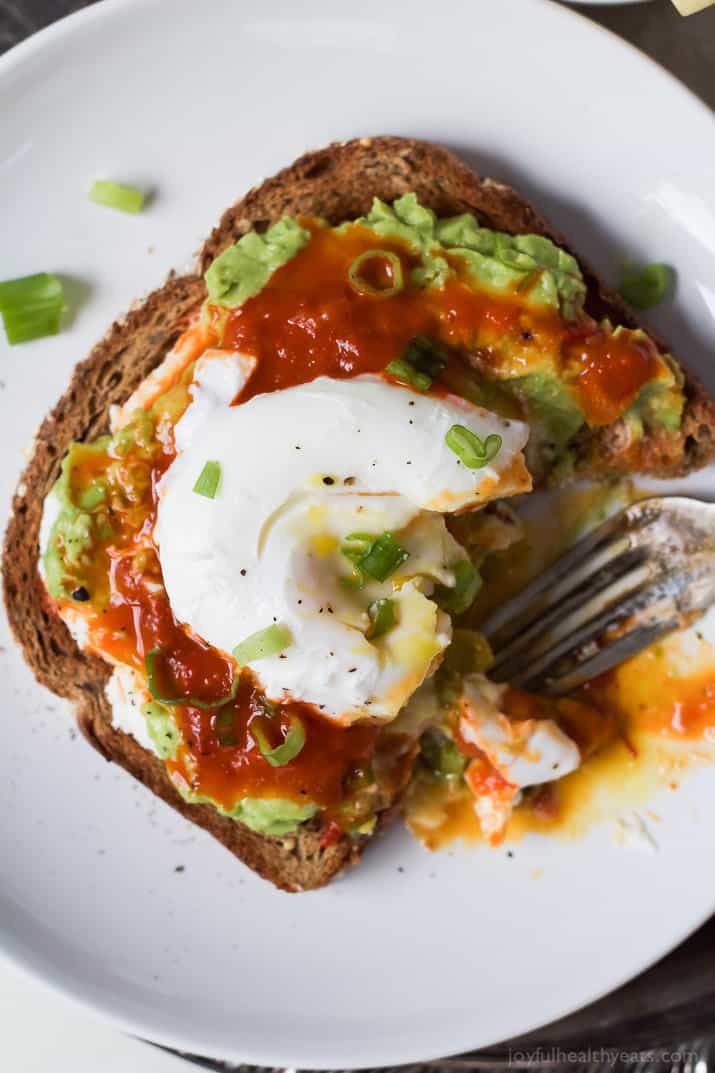 Close-up of the poached egg on the avocado toast. 