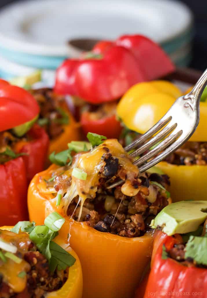 Southwestern Turkey Quinoa Stuffed Peppers filled with loads of protein and bold flavors that will leave you feeling satisfied and hungry for more all at the same time! Only 262 calories a serving! | joyfulhealthyeats.com #recipes