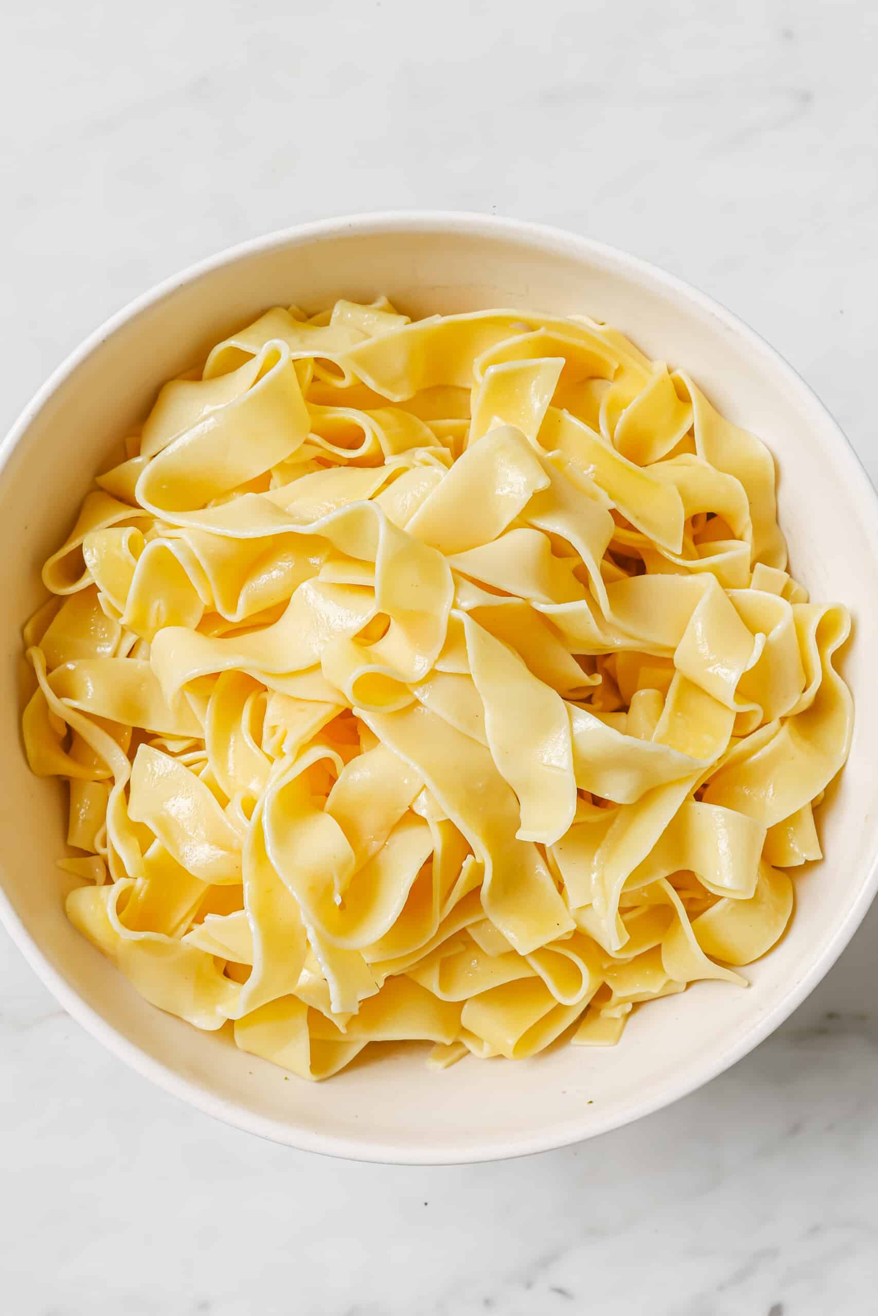 Boiled pappardelle noodles in a bowl.