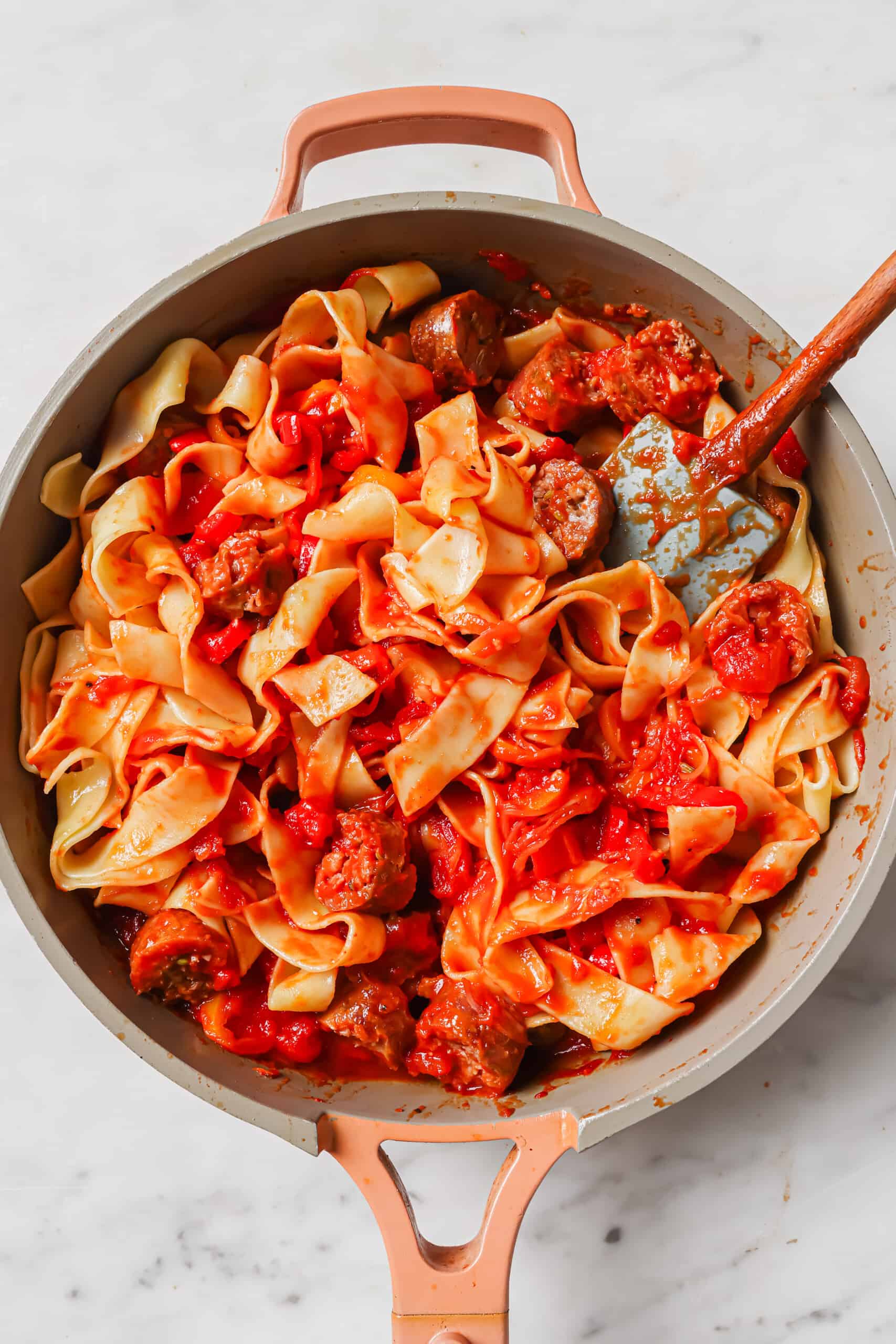 Mixed pasta and sauce in the skillet.