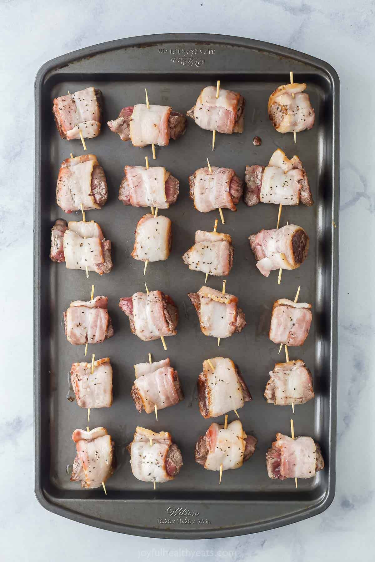 Cooling the tenderloin bites on a baking sheet. 