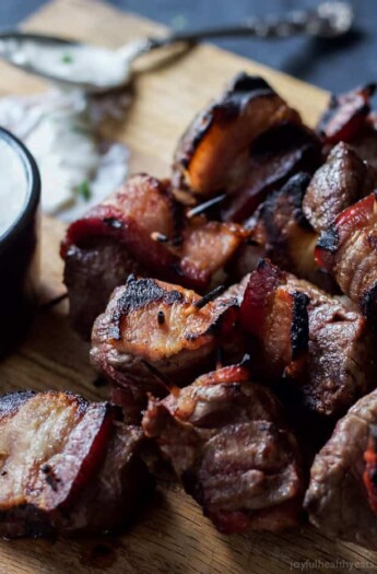 A game day appetizer you'll be fighting over! Tender Bacon Wrapped Tenderloin Bites chargrilled and served with a homemade creamy horseradish sauce! OMG! | joyfulhealthyeats.com #recipes #ad