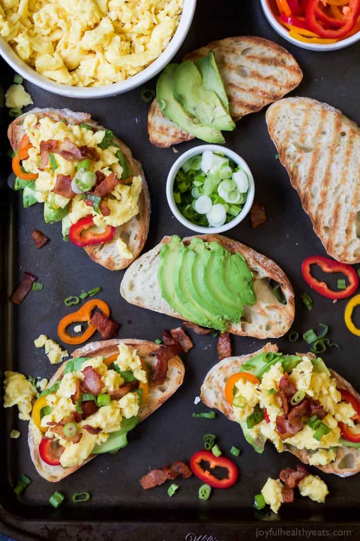 Three Completed Breakfast Bruschetta Avocado Toasts Next to Three in Progress