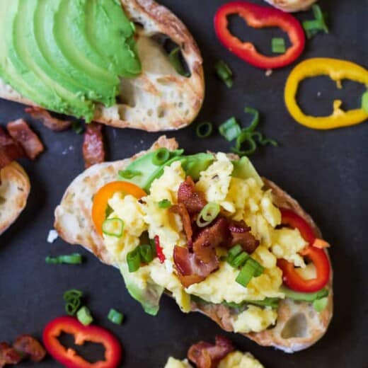 A Piece of Regular Avocado Toast Beside a Piece of Bruschetta on Avocado Toast