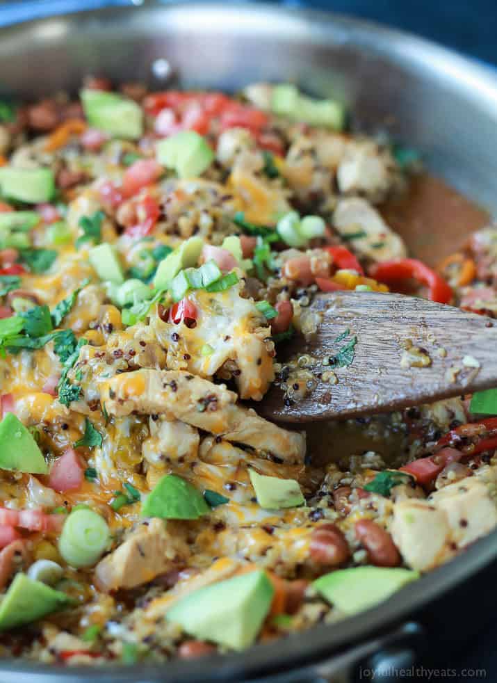 Healthy One Pot Mexican Quinoa Casserole in a pan with a wooden spoon