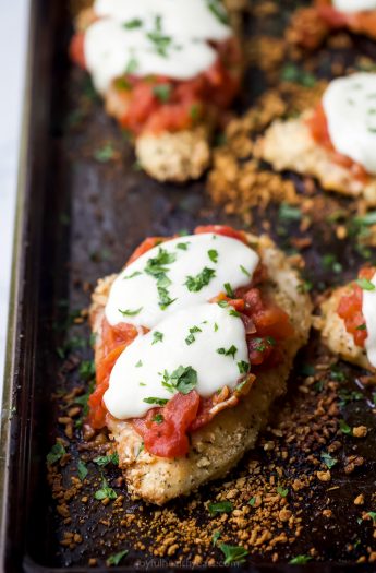 close up photo of baked chicken parmesan on a baking sheet
