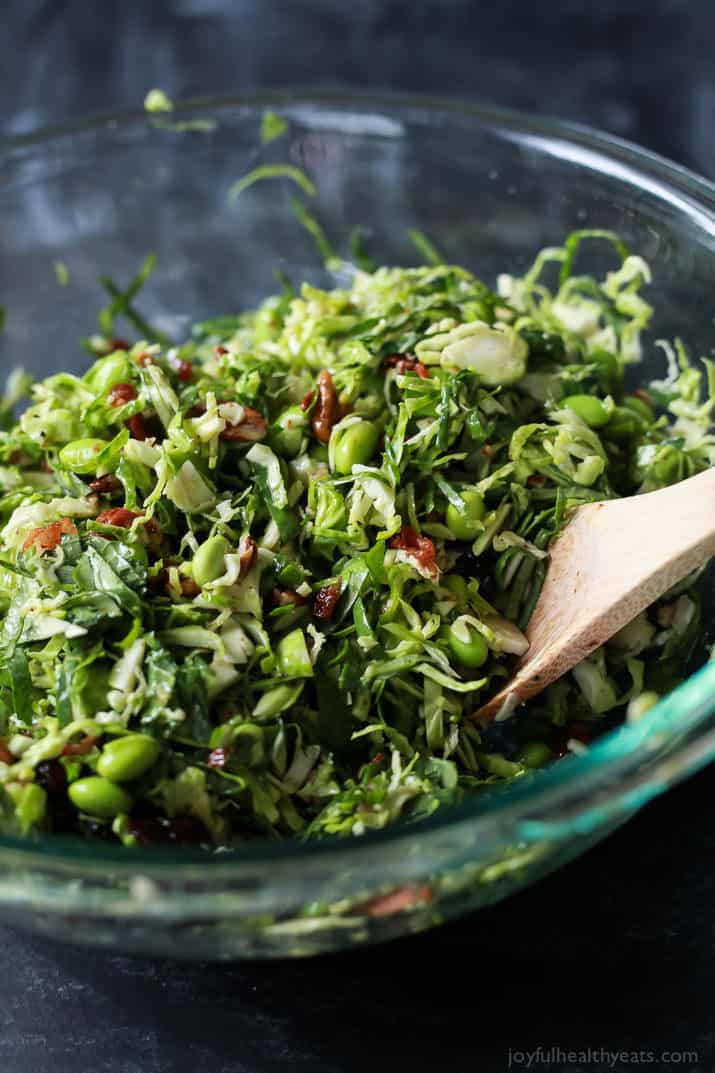 Autumn Kale & Shaved Brussel Sprout Salad ingredients in a mixing bowl