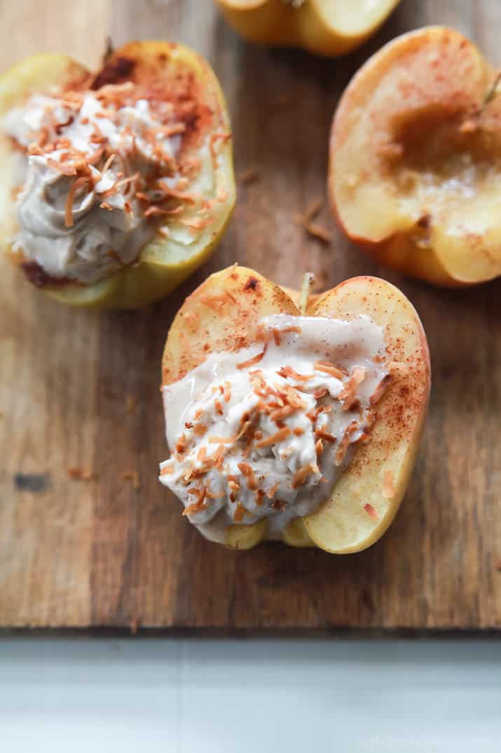 Baked Apples topped with creamy Cinnamon Mascarpone Cheese on a wooden board