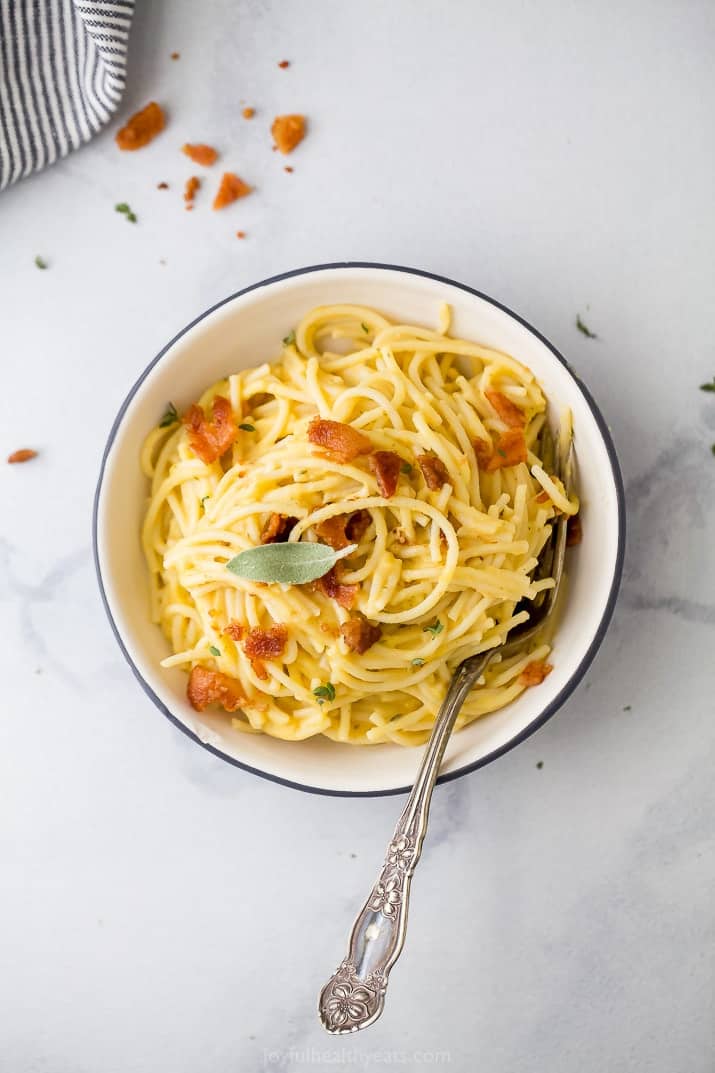 Top view of a bowl of creamy butternut squash pasta with bacon