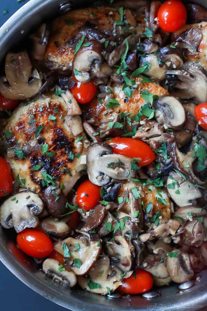 Close-up of Chicken Marsala with blistered tomatoes in a skillet