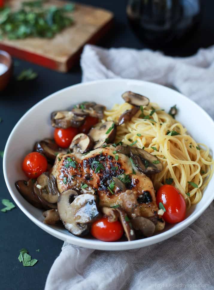 Chicken Marsala topped with Blistered Tomatoes and served over pasta in a bowl