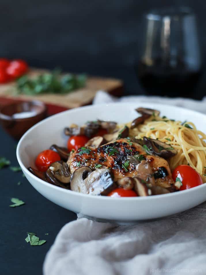 Chicken Marsala topped with Blistered Tomatoes served over pasta in a bowl